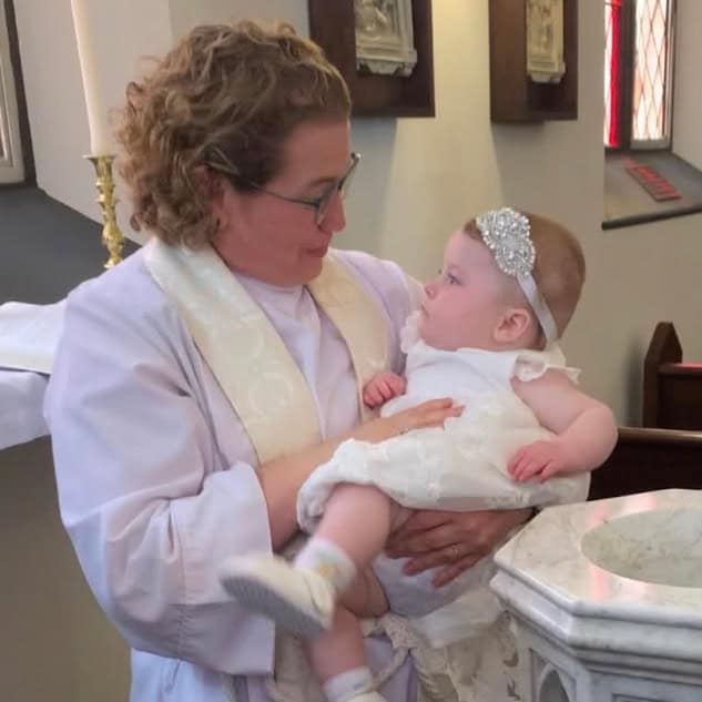 Congregation participating in a baptism ceremony at St. Augustine's Episcopal Church.